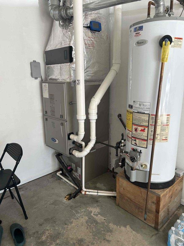 Responded to service call for 6-year-old HVAC system with confirmed refrigerant leak, no longer under warranty. Performed on-site assessment of existing equipment, documented system dimensions and current installation configuration including furnace/air handler unit and associated ductwork. Measured equipment specifications and photographed existing setup to provide accurate replacement estimate for complete system changeover.
