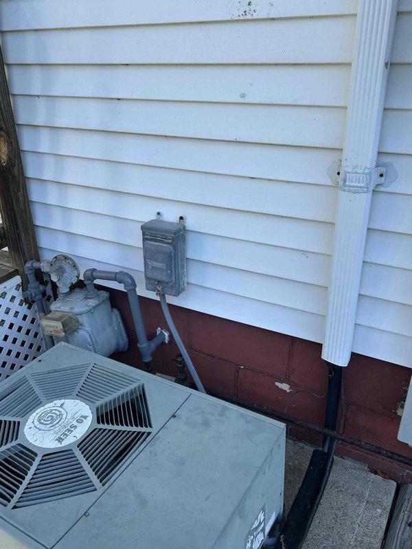 Conducted comprehensive site assessment for Space Pak air conditioning system replacement estimate. Inspected attic-mounted air handler accessed through interior closet and evaluated exterior condensing unit with reported refrigerant leak. Documented existing system configuration including flexible ductwork installation, vapor barrier condition, and outdoor unit placement adjacent to gas meter and electrical service, providing customer with complete replacement options for aging HVAC system.