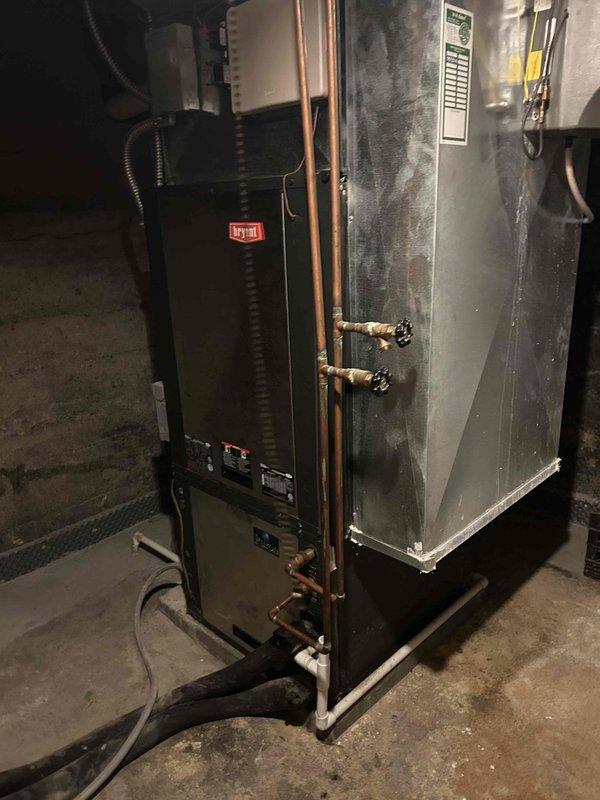 Provided estimate for complete geothermal heat pump system replacement due to refrigerant leak in existing unit with horizontal ground loop configuration. Current system, located in basement with GeoLink flow center and air handler, is experiencing reduced cooling capacity despite recent refrigerant recharge performed one week prior, indicating ongoing leak requiring full system replacement. Evaluated all-electric geothermal installation including existing pumping assembly, copper refrigerant lines, and air handler cabinet to determine scope of replacement work.