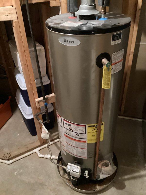 Completed estimate for replacement of gas-fired tank-type water heater in basement that had previously sustained water damage from flooding. Existing Whirlpool unit was assessed and photographed, noting current operational status despite prior water exposure. Provided replacement options and recommendations to homeowner due to potential reliability concerns from moisture infiltration affecting internal components and control systems.