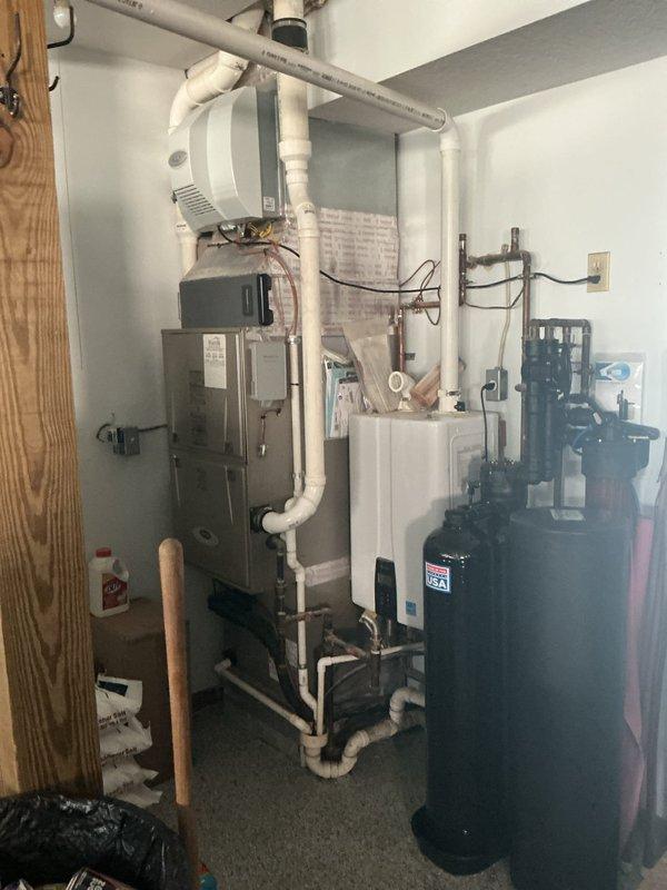 Conducted estimate for heating and cooling system replacement on second floor due to inadequate temperature control and excessive warmth. Evaluated existing HVAC equipment in mechanical room, including furnace with PVC venting system and water heater. Assessed second-floor bedroom area to determine proper equipment sizing and ductwork requirements for improved climate control and comfort.