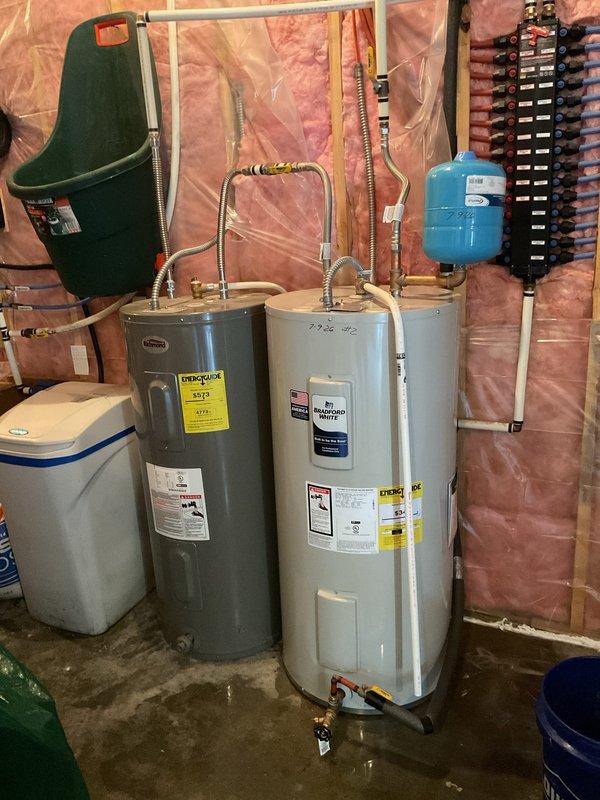 Successfully removed and replaced existing water heater with a new 40-gallon electric short water heater in walk-out basement utility room. Due to challenging access up hillside terrain, utilized two-person crew to safely extract old unit and position new equipment. Connected all supply and discharge plumbing lines, installed expansion tank, verified proper electrical connections, and tested system for leaks and proper operation. Unit is now fully functional and operational.