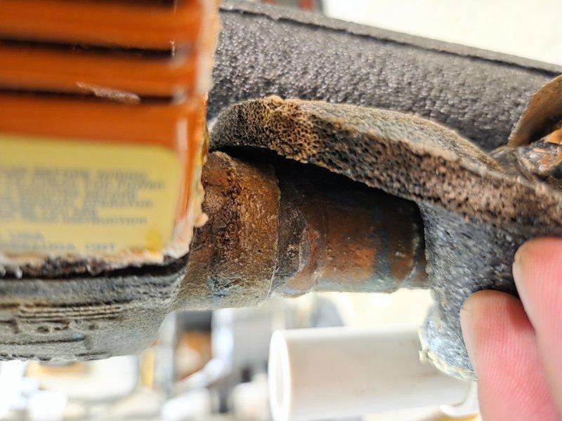 Responded to follow-up service call for system evaluation after initial no-cool complaint was temporarily resolved. Upon inspection, discovered severe corrosion and rust damage on refrigerant line connections and mechanical components, indicating advanced deterioration consistent with age of equipment. Documented compromised piping joints with heavy oxidation and structural degradation that could lead to refrigerant leaks or system failure. Advised customer of findings and discussed filter upgrade options from washable to 2-inch media filter for improved air quality and system protection.