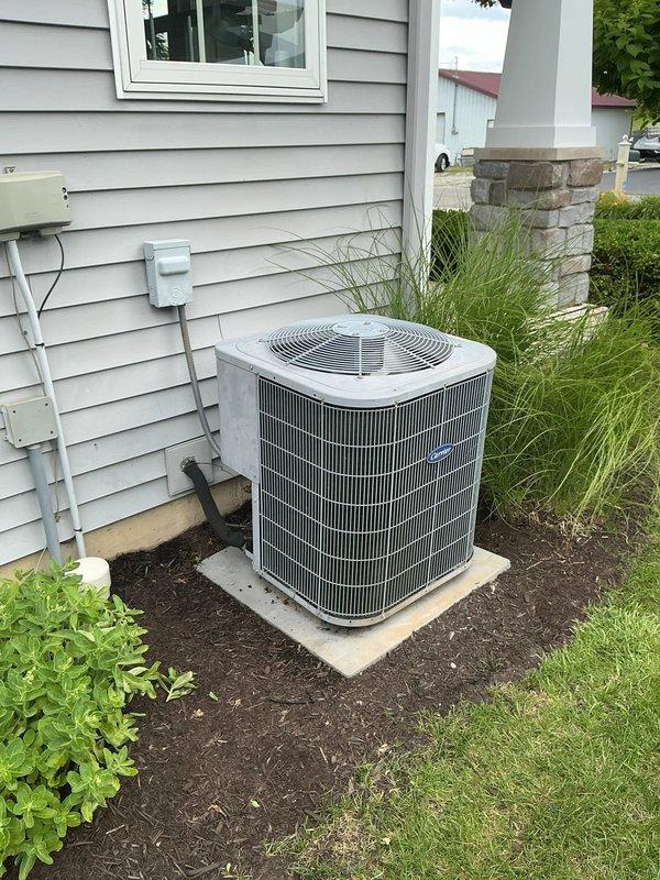 Responded to no cooling complaint and performed system evaluation. Assessed existing Carrier furnace and air conditioning condenser unit for replacement estimate. Documented current basement HVAC installation including furnace, ductwork, plenum, and PVC condensate drainage system. Inspected outdoor condenser unit positioned on concrete pad with electrical disconnect and refrigerant lines. Provided comprehensive estimate options for air conditioning replacement and potential furnace upgrade to restore cooling capability and improve system efficiency.