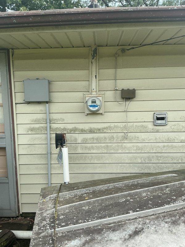 Conducted on-site evaluation for complete HVAC system replacement at residential property. Assessed existing 30-year-old furnace and air conditioning unit that has been non-operational for six years. Documented current electrical infrastructure including aged fuse panel with screw-in type fuses and exterior meter configuration. Photographed existing utility connections, conduit routing, and wall-mounted electrical components to determine compatibility requirements for new equipment installation. Evaluated structural considerations including exterior siding condition, available mounting locations, and existing service panel capacity to support modern HVAC system specifications. Provided comprehensive replacement estimate for new furnace and AC unit installation.