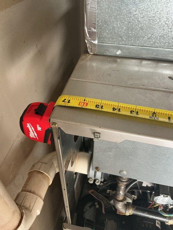 Conducted comprehensive assessment of non-operational air conditioning system and existing furnace for complete HVAC replacement estimate. Evaluated outdoor condenser unit with blue-logo branding positioned on concrete pad with proper drainage and clearances. Inspected garage-installed furnace, documenting internal components including copper refrigerant lines, gas piping, and mechanical connections. Measured existing equipment dimensions and clearances to determine replacement specifications. Photographed current system configuration, ductwork connections, and installation conditions to provide accurate replacement proposal for both heating and cooling equipment.