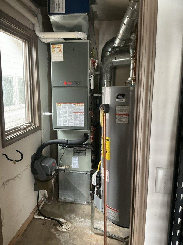 Responded to no cooling call and diagnosed failed blower motor on existing Trane furnace system. Evaluated mechanical room equipment including furnace, water heater, humidifier, and ductwork configuration. Provided estimate for complete furnace and humidifier replacement to restore system functionality.