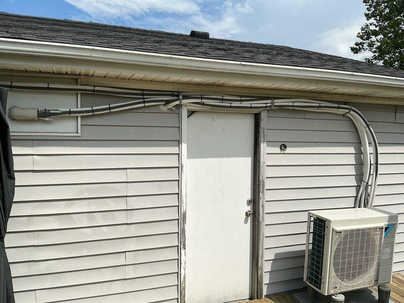 Installed Line Hide covers on exposed mini split refrigerant lines along exterior wall to improve aesthetic appearance and provide additional protection from weather elements. Verified proper insulation wrapping on refrigerant lines for adequate moisture control and condensation prevention. System operating within normal parameters upon completion of cosmetic line cover installation.