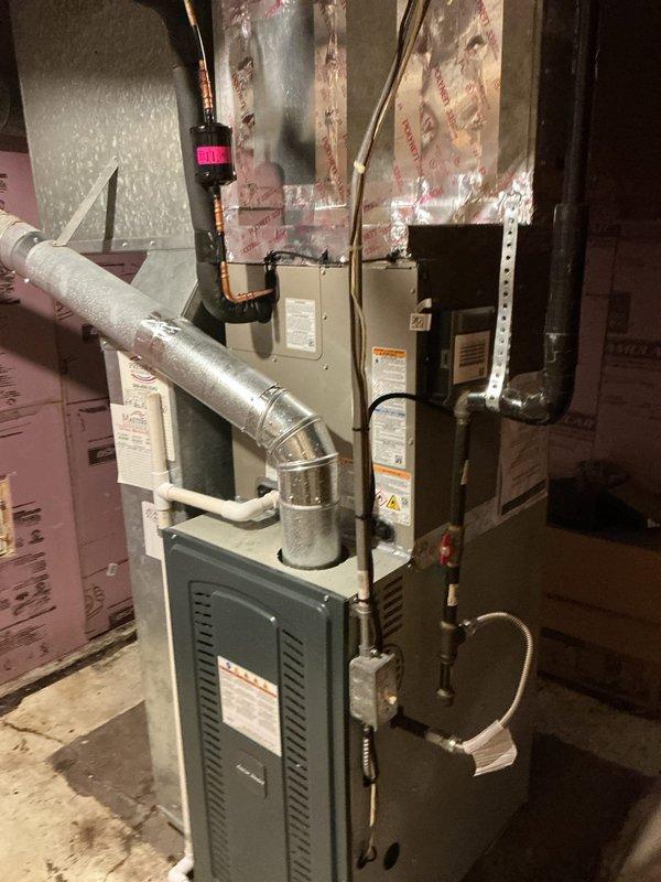 Completed full HVAC system installation consisting of a Carrier 26SCA424N003 Comfort Series single-stage air conditioner and Carrier CVAVA3017XMA evaporator coil in residential basement utility area. Removed and recycled existing equipment, then reconnected to existing line set after performing complete flush and pressure test. Installed new 2-inch condenser PVC pad with pea gravel base for outdoor unit stability. Reconnected all existing supply and return ductwork to new system, ensuring proper airflow and sealed connections. Installed new electrical disconnect and whip for outdoor condenser unit per code requirements. Registered manufacturer warranty coverage for both air conditioner and evaporator coil components, which include 10-year limited parts warranty. Conducted thorough system operation explanation and post-installation walkthrough with senior technician quality assurance inspection to verify proper installation and performance parameters.