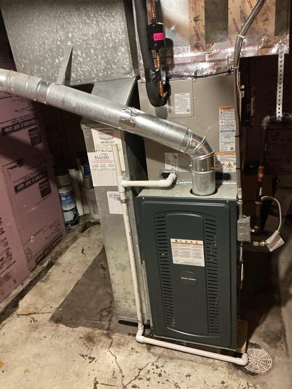 Completed full HVAC system installation consisting of a Carrier 26SCA424N003 Comfort Series single-stage air conditioner and Carrier CVAVA3017XMA evaporator coil in residential basement utility area. Removed and recycled existing equipment, then reconnected to existing line set after performing complete flush and pressure test. Installed new 2-inch condenser PVC pad with pea gravel base for outdoor unit stability. Reconnected all existing supply and return ductwork to new system, ensuring proper airflow and sealed connections. Installed new electrical disconnect and whip for outdoor condenser unit per code requirements. Registered manufacturer warranty coverage for both air conditioner and evaporator coil components, which include 10-year limited parts warranty. Conducted thorough system operation explanation and post-installation walkthrough with senior technician quality assurance inspection to verify proper installation and performance parameters.