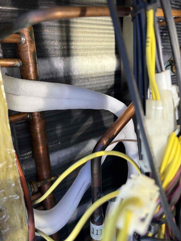 Responded to service call for commercial AC unit making clunking noise. Upon arrival, inspected ground-mounted unit and found system operational with no immediate cooling issues. Performed visual inspection of internal components including evaporator coil, refrigerant lines, and electrical connections. Coil showed normal dust accumulation for age of unit, copper lines exhibited typical oxidation, and all insulation appeared intact. Unit continued to operate normally during inspection with no unusual sounds detected at time of service.