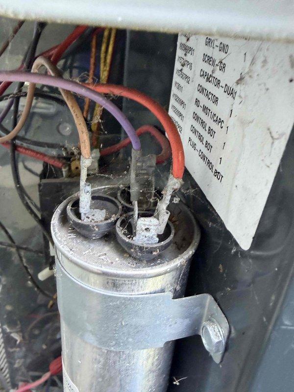 Completed air conditioning tune-up service including comprehensive system inspection and performance evaluation. Documented electrical connections and capacitor condition, noting age-related wear on terminal blocks and wiring with visible corrosion on connections and mounting hardware. All critical components photographed for service records, with dual capacitor and contactor assembly showing normal operational wear consistent with system age.
