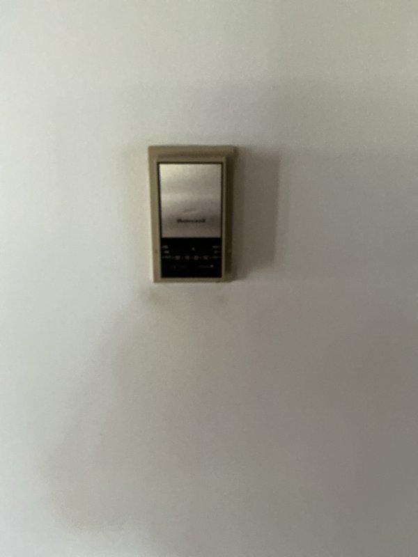 Responded to no cooling complaint on residential HVAC system. Inspected wall-mounted Honeywell thermostat and evaluated existing furnace unit for replacement estimate. Documented equipment specifications and measurements of current system, including ductwork connections and existing infrastructure to provide accurate replacement recommendations.