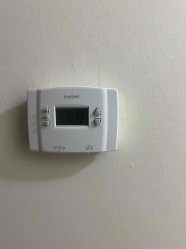 Conducted an HVAC system replacement estimate at a residential property. Assessed existing equipment including a Honeywell digital thermostat and ductwork system with visible condensation issues on metallic piping, indicating potential insulation deficiencies or temperature differential concerns. Documented current system conditions and provided replacement options for complete HVAC system upgrade.