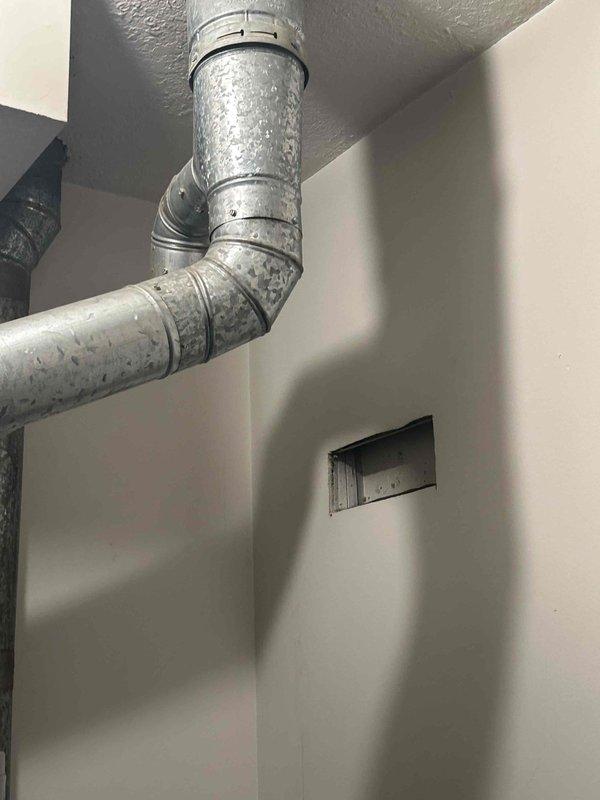 Conducted an HVAC system replacement estimate at a residential property. Assessed existing equipment including a Honeywell digital thermostat and ductwork system with visible condensation issues on metallic piping, indicating potential insulation deficiencies or temperature differential concerns. Documented current system conditions and provided replacement options for complete HVAC system upgrade.