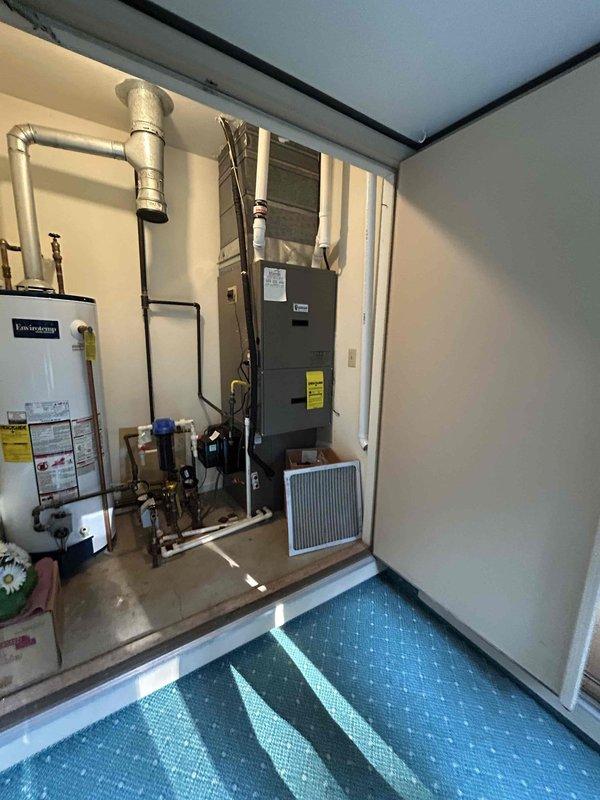 Responded to no cooling call and conducted system evaluation of existing HVAC equipment. Assessed vertically-mounted air handler unit and furnace system located in residential utility closet alongside water heater. Documented current equipment configuration including ductwork connections, refrigerant lines, condensate drain lines, and electrical components. Prepared comprehensive replacement estimate for complete air conditioning and furnace system upgrade. Coordinated morning appointment time and provided customer communication regarding next steps for equipment replacement.