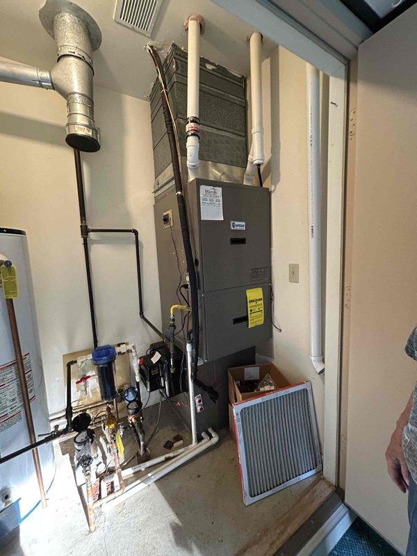 Responded to no cooling call and conducted system evaluation of existing HVAC equipment. Assessed vertically-mounted air handler unit and furnace system located in residential utility closet alongside water heater. Documented current equipment configuration including ductwork connections, refrigerant lines, condensate drain lines, and electrical components. Prepared comprehensive replacement estimate for complete air conditioning and furnace system upgrade. Coordinated morning appointment time and provided customer communication regarding next steps for equipment replacement.