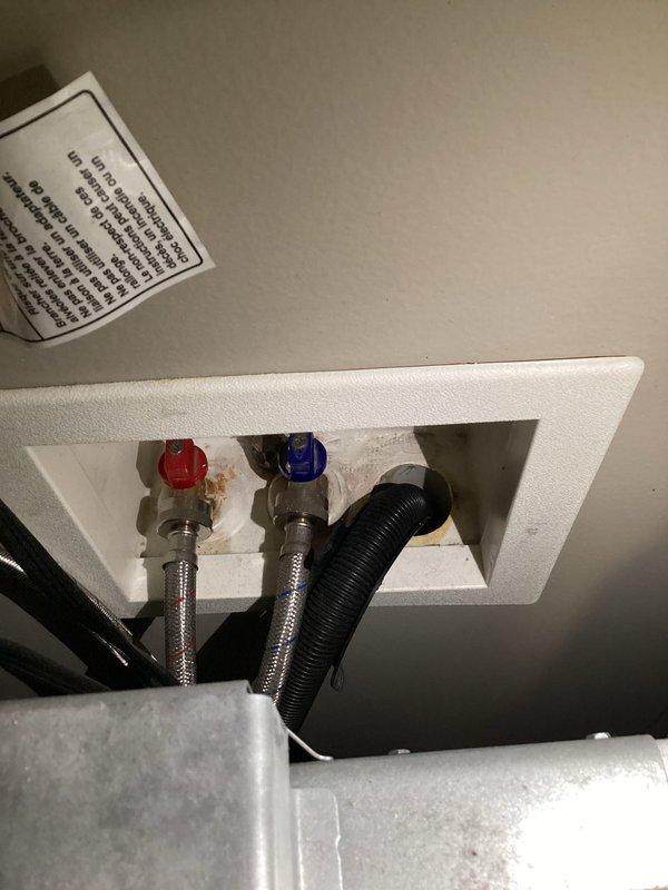 # Plumbing Maintenance Inspection Completed

Performed comprehensive plumbing maintenance inspection at installation site. Inspected and documented washing machine water supply connections through ceiling access panel, verifying proper installation of braided stainless steel flex lines with color-coded hot and cold fittings. Examined under-sink plumbing assembly including PVC P-trap configuration, garbage disposal mounting, and dishwasher drain connection. Verified all supply lines, drain components, and connections are secure and functioning properly with no visible leaks or defects detected.