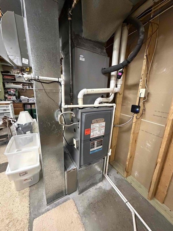 Completed first prepaid cooling maintenance visit on residential HVAC system. Performed comprehensive inspection of indoor furnace unit located in basement mechanical room, checking all accessible components, connections, and venting systems. Inspected outdoor condenser unit, noting operational condition of heat exchanger coils and overall equipment status. System photographed and documented for maintenance records.