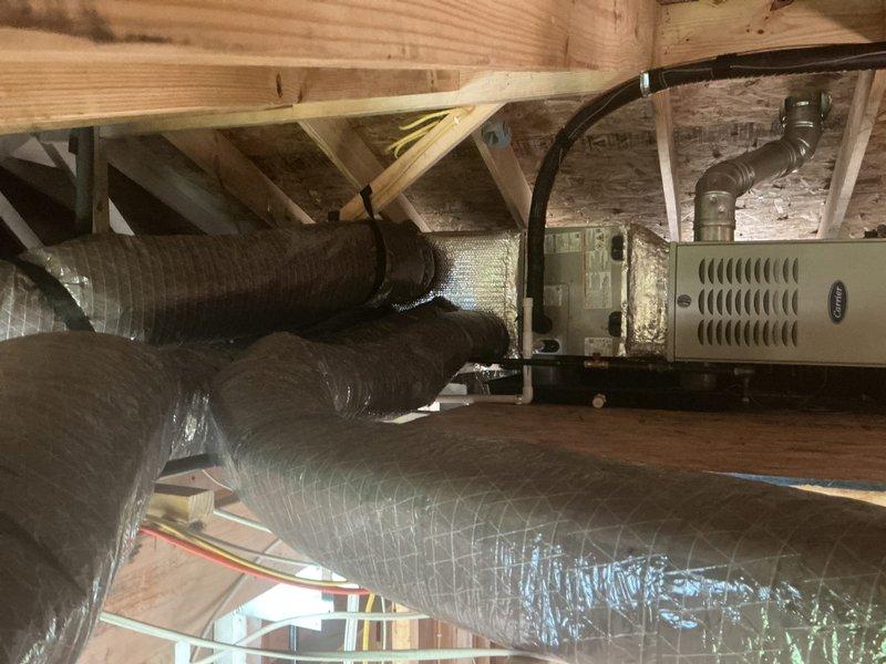 Completed full HVAC system replacement in attic space, including installation of Carrier 70,000 BTU 80% efficient natural gas furnace with ECM blower and single-stage burner, Carrier 24,000 BTU 14 SEER air conditioner with R-454B refrigerant, and matching cased horizontal evaporator coil. Installed complete new ductwork system throughout attic, including supply and return air ducts with R-8 insulation rating. Insulated all metal ductwork with R-8 insulation to meet efficiency standards. Installed Honeywell 4-inch media air filter, Honeywell fresh air damper ducted to exterior per code requirements, and Honeywell digital thermostat with new low voltage wiring throughout. Ran and pressure tested new gas piping as required for furnace connection. Installed new B-vent flue pipe for proper combustion venting. Established condensate drain line with auxiliary drain pan and safety wet switch for overflow protection. Installed new bathroom exhaust fan with exterior venting and new dryer vent te