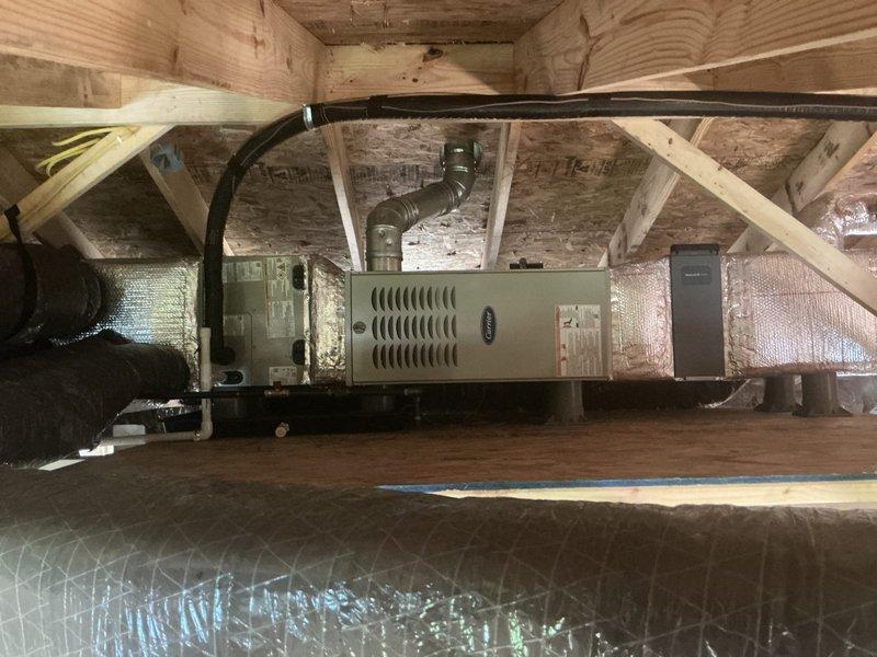Completed full HVAC system replacement in attic space, including installation of Carrier 70,000 BTU 80% efficient natural gas furnace with ECM blower and single-stage burner, Carrier 24,000 BTU 14 SEER air conditioner with R-454B refrigerant, and matching cased horizontal evaporator coil. Installed complete new ductwork system throughout attic, including supply and return air ducts with R-8 insulation rating. Insulated all metal ductwork with R-8 insulation to meet efficiency standards. Installed Honeywell 4-inch media air filter, Honeywell fresh air damper ducted to exterior per code requirements, and Honeywell digital thermostat with new low voltage wiring throughout. Ran and pressure tested new gas piping as required for furnace connection. Installed new B-vent flue pipe for proper combustion venting. Established condensate drain line with auxiliary drain pan and safety wet switch for overflow protection. Installed new bathroom exhaust fan with exterior venting and new dryer vent te