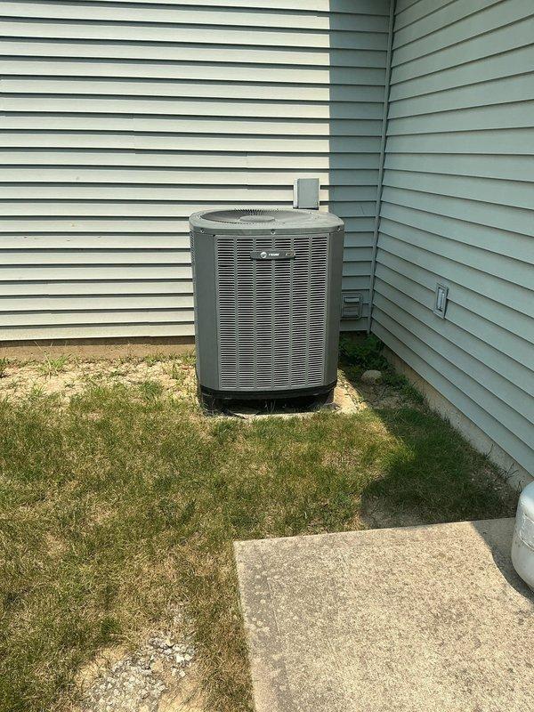 Responded to no cooling complaint and confirmed refrigerant leak at top of evaporator coil in R410A system. Documented existing Trane furnace with air handler installation and outdoor condensing unit positioned in side yard. Provided estimate for complete HVAC system replacement including new condenser, evaporator coil, and associated components due to coil leak requiring system upgrade.