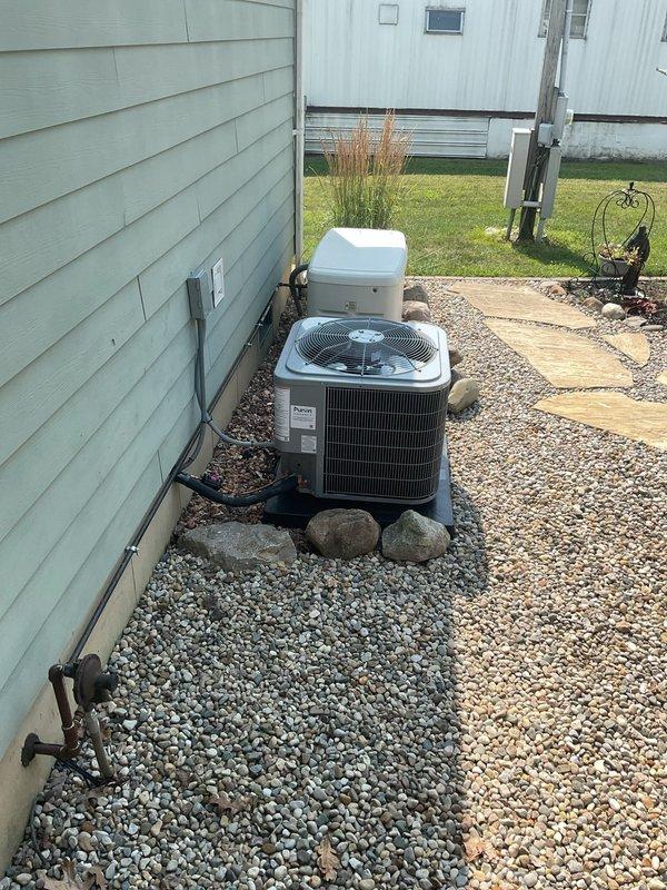Completed full system installation of Carrier Comfort Series 26SCA436N003 single-stage air conditioning condenser unit with matching Carrier CVAVA3617XMA mobile home evaporator coil at residential property. Removed and properly recycled existing HVAC equipment in accordance with EPA refrigerant recovery regulations.

Installed new condenser unit on 2-inch PVC pad with pea gravel base for proper drainage and equipment support. Reconnected unit to existing refrigerant line set after performing complete system flush and pressure test to verify integrity and absence of leaks. Installed new electrical disconnect box and whip to meet current electrical code requirements. Ran and secured refrigerant lines along exterior wall using appropriate hangers and protection.

Inside the residence, installed mobile home-specific evaporator coil and reconnected to existing supply and return ductwork. Verified all duct connections were properly sealed and secured. Installed Honeywell FocusPro S200 progra