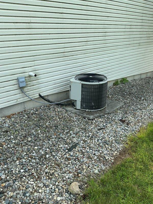 Responded to no cooling complaint on 20-year-old residential air conditioning system that had experienced freeze-up and was not maintaining temperature. Performed comprehensive evaluation of existing Bryant furnace located in unfinished basement and outdoor condensing unit positioned on gravel pad against building exterior. Assessed refrigerant lines, PVC drainage and venting components, ductwork configuration, and overall system condition to provide complete replacement estimate for aging HVAC equipment that was no longer keeping up with cooling demands.
