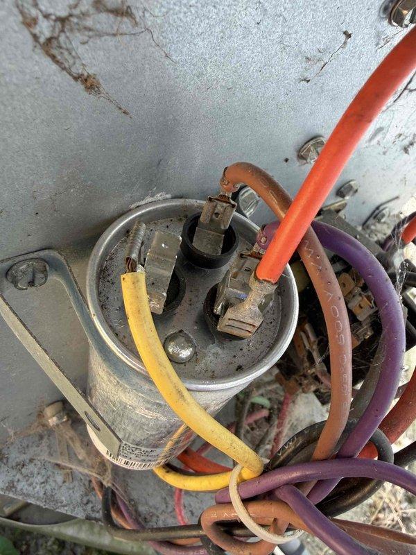 Responded to no cooling call on 10+ year old system. Upon arrival, found unit not blowing air. Inspected electrical components and capacitor mounted in ceiling assembly, noting age-related wear and accumulated dirt on wiring connections. Evaluated heavily soiled air filter with significant dust and debris accumulation restricting airflow. Addressed airflow issue and restored system operation.
