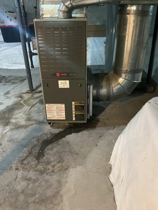 Conducted on-site assessment for air conditioning system installation at residential property with existing Trane furnace but no previous AC system. Evaluated current HVAC infrastructure including furnace unit, ductwork configuration, and basement utility space layout to determine appropriate AC unit sizing and installation requirements. Documented existing equipment conditions, noting moisture concerns on concrete flooring near furnace base and available space for outdoor condenser placement. Assessed electrical panel capacity and existing duct system compatibility for seamless AC integration with current forced-air heating system. Provided comprehensive estimate for complete air conditioning unit installation including condensing unit, evaporator coil, refrigerant lines, electrical connections, and necessary modifications to existing ductwork to accommodate cooling distribution throughout home.