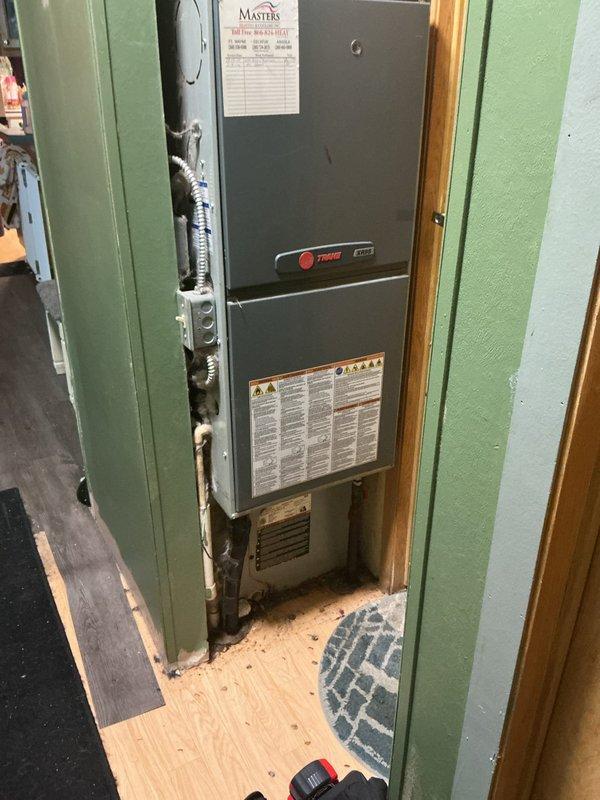 Responded to no-cool complaint on residential air conditioning system. Evaluated existing Trane HVAC system with failed compressor utilizing R22 refrigerant. Documented indoor furnace unit installed in utility closet and outdoor condensing unit positioned on exterior side yard. Photographed current equipment configuration including refrigerant line routing, electrical connections, and installation clearances. Provided estimate for complete system replacement due to obsolete R22 refrigerant and failed compressor making repair economically unfeasible. Discussed financing options with customer for new equipment installation.