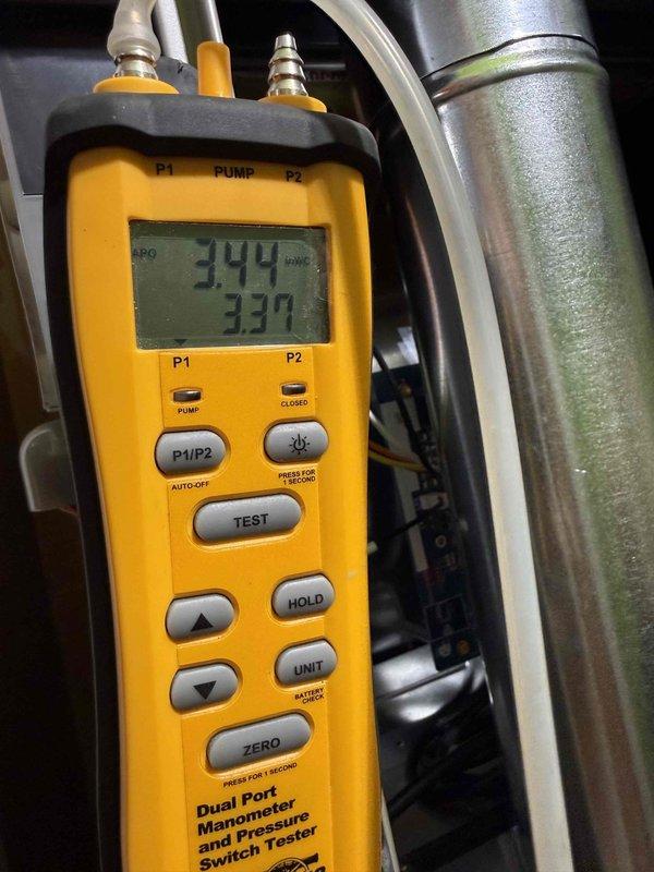 Completed full HVAC system replacement including installation of Carrier 26TPA824W003 Performance Series two-stage air conditioner, Carrier CVAVA3017XMA evaporator coil, and Carrier 58TP0B070V17-16 Performance Series two-stage non-condensing gas furnace rated at 70,000 BTU. Installed Honeywell Elite Pro S1200 thermostat for system control. Removed and properly recycled existing equipment from utility closet location with lime green walls showing previous water damage near floor level.

Installed new 2-inch PVC condenser pad with pea gravel base for outdoor unit placement. Reconnected existing supply and return ductwork to new furnace unit. Completed furnace changeout using #2 installation kit for 80% to 90% efficiency upgrade. Verified all electrical connections, gas line connections, and refrigerant line sets were properly secured and sealed.

Performed system startup and commissioning procedures. Utilized dual port manometer to verify proper static pressures, recording readings of 3.