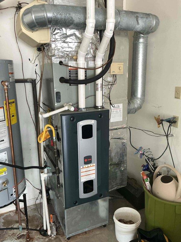 Completed first prepaid cooling maintenance visit on residential HVAC system located in basement utility area. Performed comprehensive inspection of furnace unit, air handler, evaporator coil housing, and associated ductwork including galvanized metal ducts and T-junctions. Verified proper operation of condensate drain lines (white PVC), checked refrigerant line connections, and inspected electrical connections throughout the system. All components found to be functioning within normal parameters with no immediate service needs identified.