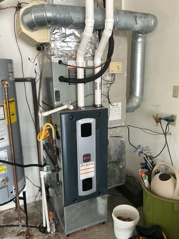 Completed first prepaid cooling maintenance visit on residential HVAC system located in basement utility area. Performed comprehensive inspection of furnace unit, air handler, evaporator coil housing, and associated ductwork including galvanized metal ducts and T-junctions. Verified proper operation of condensate drain lines (white PVC), checked refrigerant line connections, and inspected electrical connections throughout the system. All components found to be functioning within normal parameters with no immediate service needs identified.