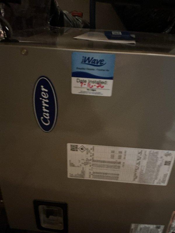 # Summary

Successfully completed geothermal HVAC system installation in attic space, including Carrier air handler unit with integrated iWave air purification system, properly configured ductwork, and condensate drainage system.

# Work Performed

Installed complete geothermal heating and cooling system in attic utility space. Positioned and secured Carrier brand air handler unit on OSB platform with appropriate structural support. Integrated iWave air purification technology into the air handler to enhance indoor air quality through ionization. Connected large-diameter flexible supply ductwork with proper insulation to minimize thermal loss and ensure efficient air distribution throughout the structure. 

Installed black refrigerant line set with appropriate insulation wrapping to prevent condensation and maintain system efficiency. Configured secondary equipment unit with reflective insulation barrier for temperature control and energy efficiency. Established proper condensate manag