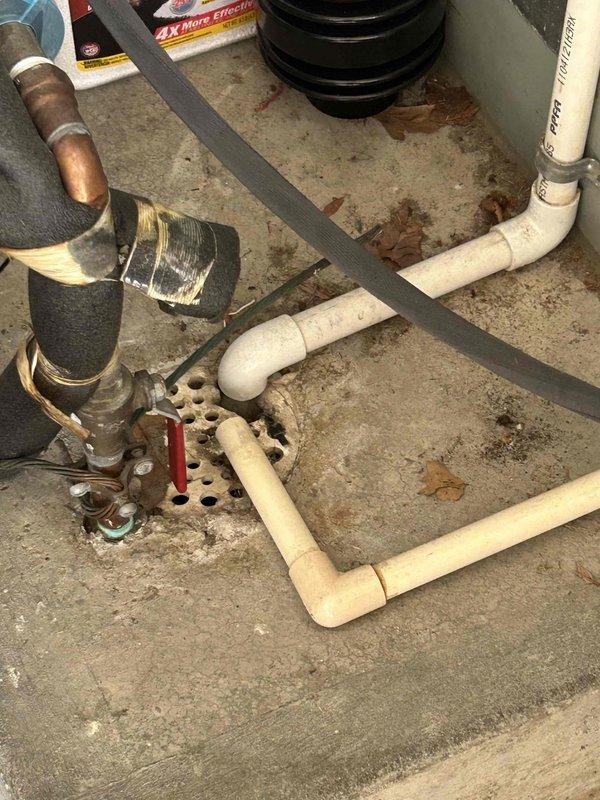 Conducted comprehensive on-site estimate for complete HVAC system replacement including air conditioning unit and gas furnace. Evaluated existing exterior AC condenser unit with circular fan grille mounted on gravel pad adjacent to home with white vinyl siding, assessed electrical disconnect and conduit configuration. Inspected interior mechanical room plumbing infrastructure including brass valve assembly with insulated copper piping, PVC drainage systems, and existing furnace connections to determine replacement specifications and compatibility requirements for new equipment installation.