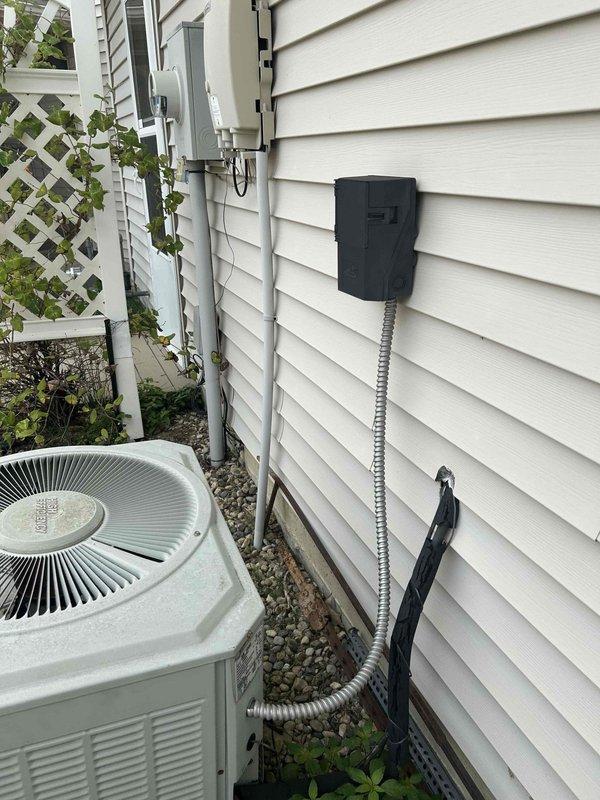 Conducted comprehensive on-site estimate for complete HVAC system replacement including air conditioning unit and gas furnace. Evaluated existing exterior AC condenser unit with circular fan grille mounted on gravel pad adjacent to home with white vinyl siding, assessed electrical disconnect and conduit configuration. Inspected interior mechanical room plumbing infrastructure including brass valve assembly with insulated copper piping, PVC drainage systems, and existing furnace connections to determine replacement specifications and compatibility requirements for new equipment installation.