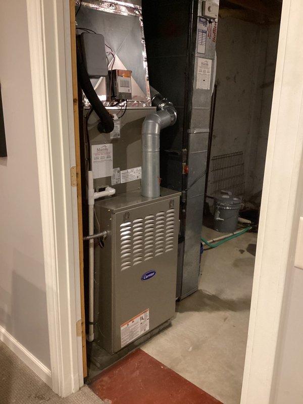 Completed full HVAC system replacement in basement mechanical room. Removed and recycled existing equipment, then installed new Carrier Performance Series two-stage air conditioner (model 26TPA836W003), Carrier 80% AFUE two-stage gas furnace with variable-speed ECM blower motor (model 58TP0B110V21-22), and Carrier evaporator coil (model CVAVA4221XMA). Installed Honeywell Elite Pro S1200 thermostat for system control. Reconnected unit to existing refrigerant line set, performed complete flush and pressure test to verify system integrity. Installed new electrical disconnect and whip for proper power supply. All ductwork connections secured to furnace plenum with metallic transitions. Obtained necessary permits for installation compliance. Conducted system startup, verified proper operation of two-stage heating and cooling functions, and confirmed variable-speed blower motor performance across all stages. Performed post-installation quality assurance inspection and walkthrough, explaining