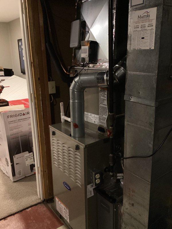 Completed full HVAC system replacement in basement mechanical room. Removed and recycled existing equipment, then installed new Carrier Performance Series two-stage air conditioner (model 26TPA836W003), Carrier 80% AFUE two-stage gas furnace with variable-speed ECM blower motor (model 58TP0B110V21-22), and Carrier evaporator coil (model CVAVA4221XMA). Installed Honeywell Elite Pro S1200 thermostat for system control. Reconnected unit to existing refrigerant line set, performed complete flush and pressure test to verify system integrity. Installed new electrical disconnect and whip for proper power supply. All ductwork connections secured to furnace plenum with metallic transitions. Obtained necessary permits for installation compliance. Conducted system startup, verified proper operation of two-stage heating and cooling functions, and confirmed variable-speed blower motor performance across all stages. Performed post-installation quality assurance inspection and walkthrough, explaining