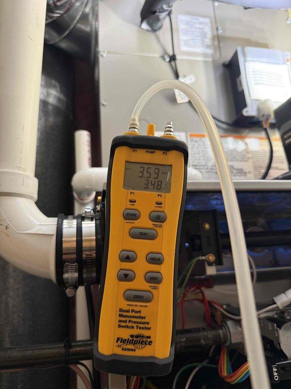 Completed full HVAC system replacement including installation of Carrier 59MN7C060C17-14 Infinity Series 98% AFUE modulating gas furnace with communicating capabilities, Carrier 26SPA624W003 Performance Series single-stage air conditioner, and Carrier CVAVA3017XMA evaporator coil. Removed and recycled existing equipment, reconnected to existing line set after flushing and pressure testing, and installed new 2" PVC condenser pad with pea gravel base. Upgraded from 80% efficiency system to 96%+ high-efficiency system requiring #2 installation kit for furnace changeout, installed white PVC condensate drainage system with proper routing and pitch, and mounted Honeywell Elite Pro S1200 thermostat with full programming and system explanation. Verified proper airflow, combustion analysis, and pressure switch operation using digital manometer showing differential pressures of 359 and 348 pascals, confirmed all electrical connections and safety controls operational, registered equipment warrant