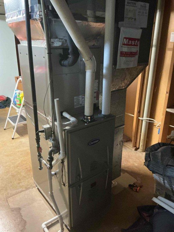Completed scheduled cooling maintenance on Carrier split system. Inspected outdoor condenser unit and indoor furnace, verified proper operation of all components, checked refrigerant lines and condensate drainage, and documented system condition with photographs. All equipment operating within normal parameters.