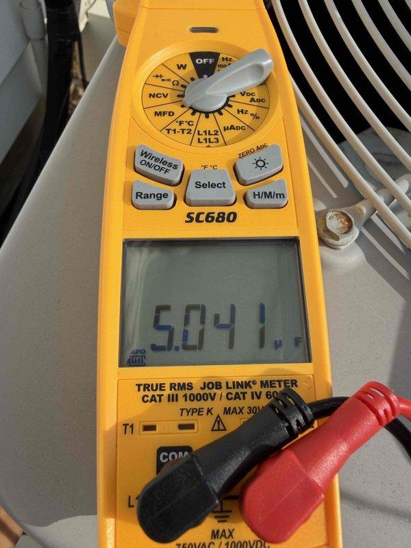 Performed comprehensive air conditioning tune-up including system diagnostics and electrical testing. Measured capacitor performance using digital multimeter, recording readings of 5.041 and 40.11 microfarads to verify proper compressor and fan motor operation. Inspected condenser unit components, confirmed voltage levels within manufacturer specifications, and ensured all electrical connections were secure for optimal system performance.