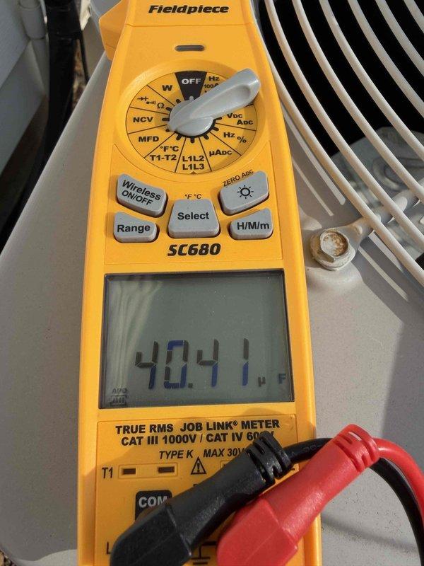 Performed comprehensive air conditioning tune-up including system diagnostics and electrical testing. Measured capacitor performance using digital multimeter, recording readings of 5.041 and 40.11 microfarads to verify proper compressor and fan motor operation. Inspected condenser unit components, confirmed voltage levels within manufacturer specifications, and ensured all electrical connections were secure for optimal system performance.