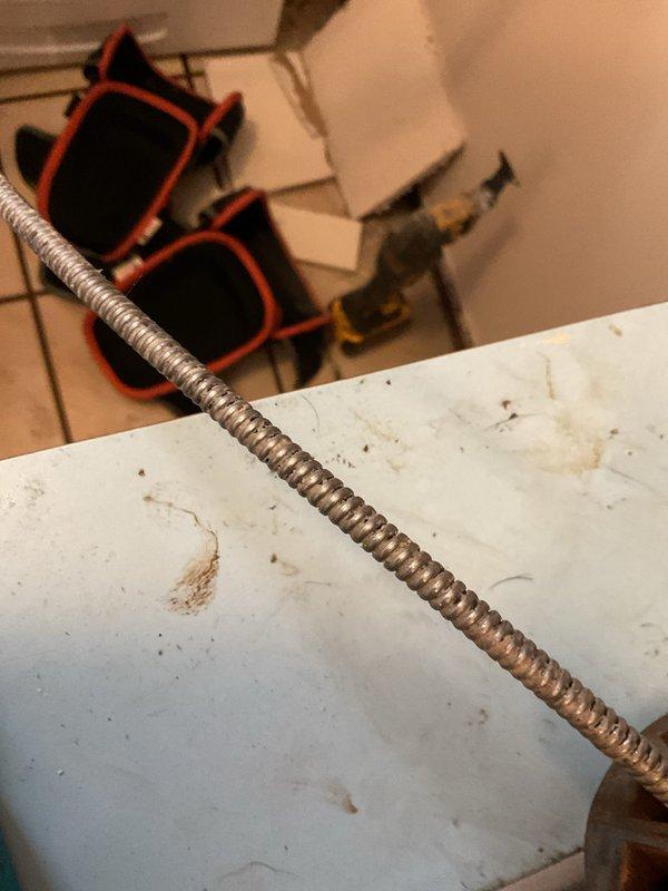 Responded to reported water leak initially attributed to dishwasher but identified actual source as corroded copper waterlines serving the washing machine. Performed comprehensive plumbing repair including removal of outdated washer box and deteriorated copper supply lines. Cut drywall access panel to expose and extract existing washer box and corroded piping running between floors.

Installed new washer box with PEX adapters and ran new supply lines through floor penetration into basement. Reconnected new PEX lines to existing copper plumbing in basement. Performed thorough drain snake service on washing machine drain line to ensure complete clearance and prevent future backup issues.

Replaced leaking utility sink faucet in laundry area to eliminate active water damage concern. Upgraded water heater shut-off valves by removing outdated gate valves and installing new ball valves for improved reliability and ease of operation. All work completed to code with proper connections and leak