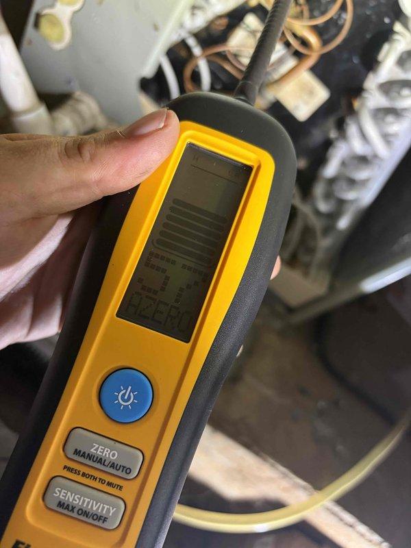Responded to no cooling complaint on residential air conditioning system with history of refrigerant leak from 2017. Upon arrival, performed diagnostic evaluation of outdoor condensing unit and indoor evaporator coil system. Utilized electronic leak detection equipment to inspect refrigerant circuit and identify source of system failure. Documented equipment condition with photos showing outdoor condenser unit and leak detection process at indoor coil assembly.