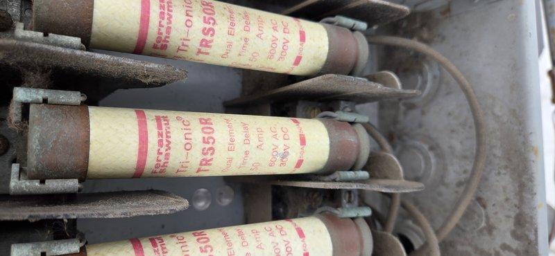 Responded to no cooling call on 10+ year old rooftop unit. Upon inspection, found failed 50 amp 600V fuses in the main disconnect. Replaced all three TRS350R fuses, verified proper electrical connections, and tested contactors for proper operation. Unit restored to normal cooling operation with all electrical components functioning within specifications.