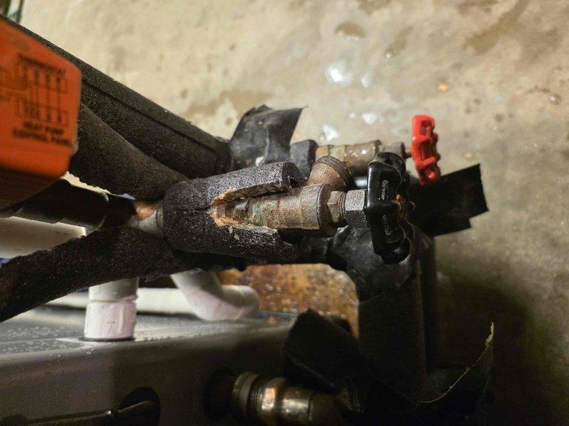 Responded to service call regarding geothermal system valve component. Inspected heavily corroded brass pipe fittings and connections showing significant oxidation and deterioration. Assessed condition of existing foam pipe insulation on mechanical components and documented current state of plumbing connections for parts ordering and follow-up repair scheduling.