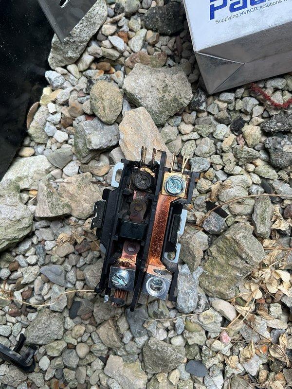 Responded to no cooling complaint on commercial HVAC unit with tripped breaker that would not reset. Upon inspection, found failed contactor with severely corroded copper bus bars and terminals preventing proper electrical operation. Replaced defective contactor with new unit, restored power, and verified system operation.