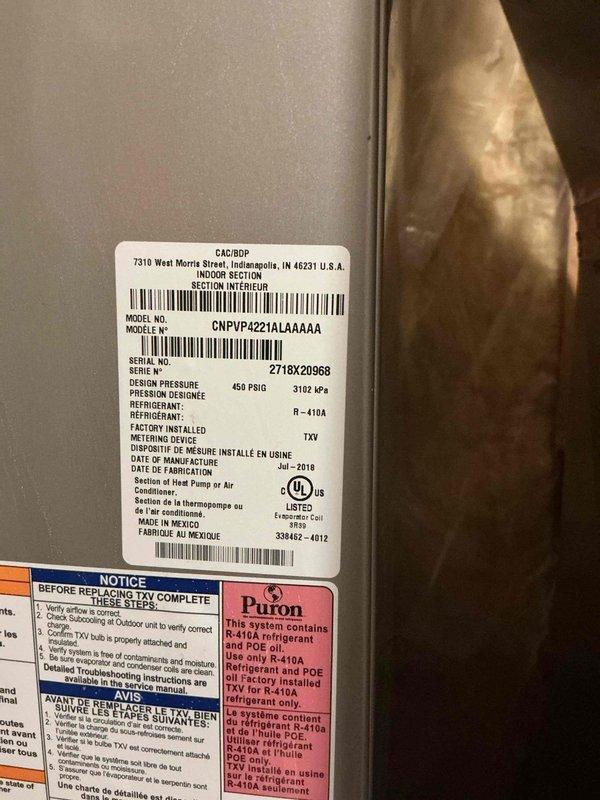 Performed preventive maintenance tune-up on Carrier air conditioning system, model CNPVP4221ALA4AAA, utilizing R-410A refrigerant. Completed comprehensive inspection of unit exterior, verified manufacturer specifications and safety labels, and documented equipment condition through photographic records for maintenance history.