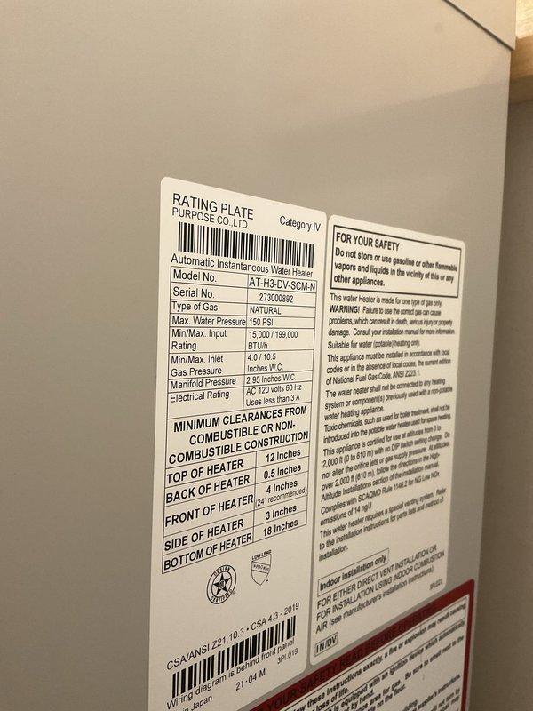 Responded to service call for leaking tankless water heater unit. Upon arrival, inspected wall-mounted tankless water heater system installed in recessed cabinet space. Removed front access panel to expose internal components including circuit boards, wiring harnesses, heat exchanger elements, and control mechanisms. Identified source of leak and assessed condition of unit, which is an AT-H3-DV-SCM-N model natural gas tankless water heater with 15,000-199,000 BTU capacity. Examined all water connections, including inlet and outlet piping, pressure relief valve, and condensate drain system. Inspected venting system including metal elbow joint and flexible vent pipe for proper installation and potential moisture intrusion points. Evaluated electrical connections and control panel functionality. Documented unit specifications and current installation configuration with detailed photographs for service records and potential warranty claim or replacement recommendations.